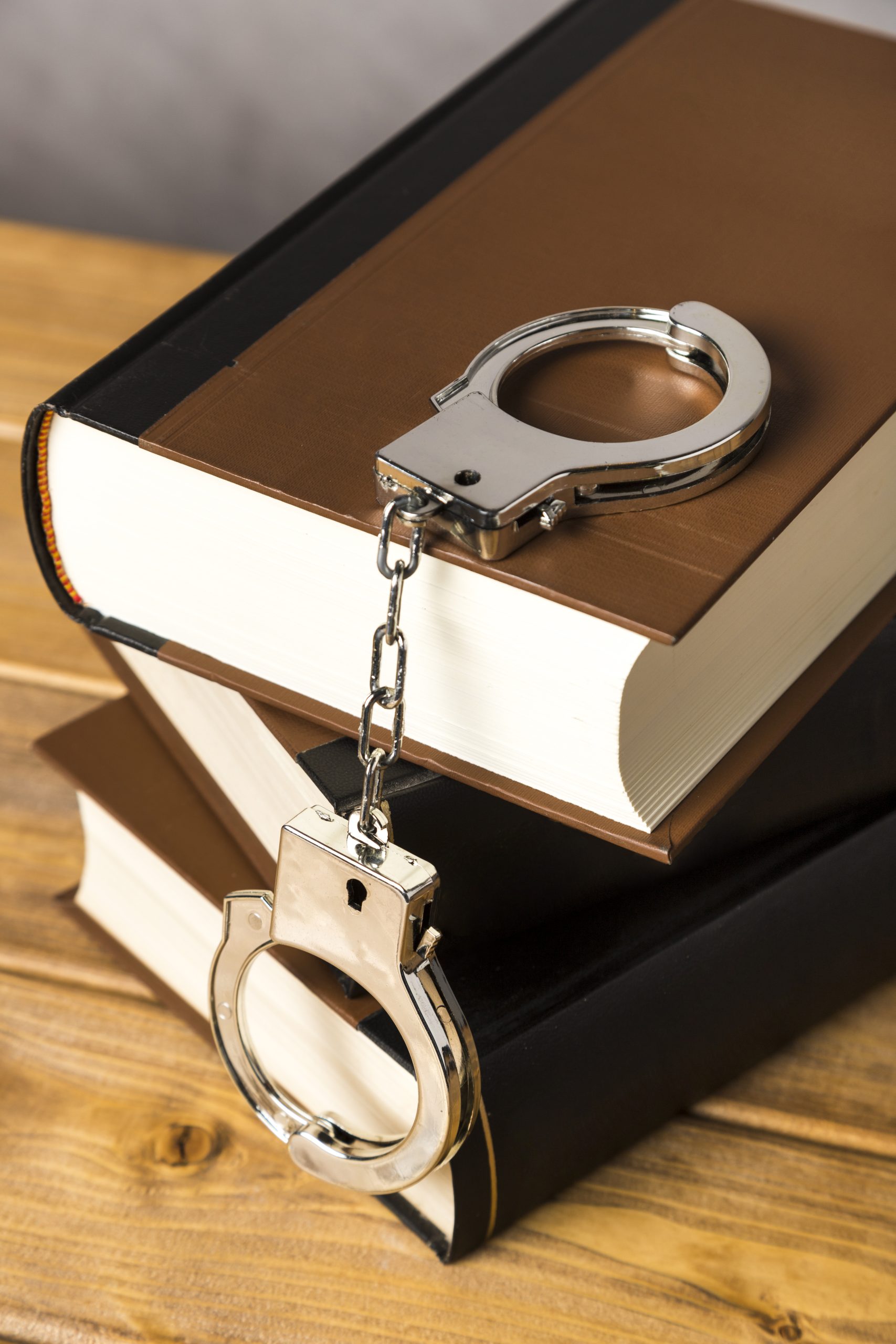 https://bttlawyers.com/wp-content/uploads/2025/01/close-up-with-handcuffs-books-scaled.jpg